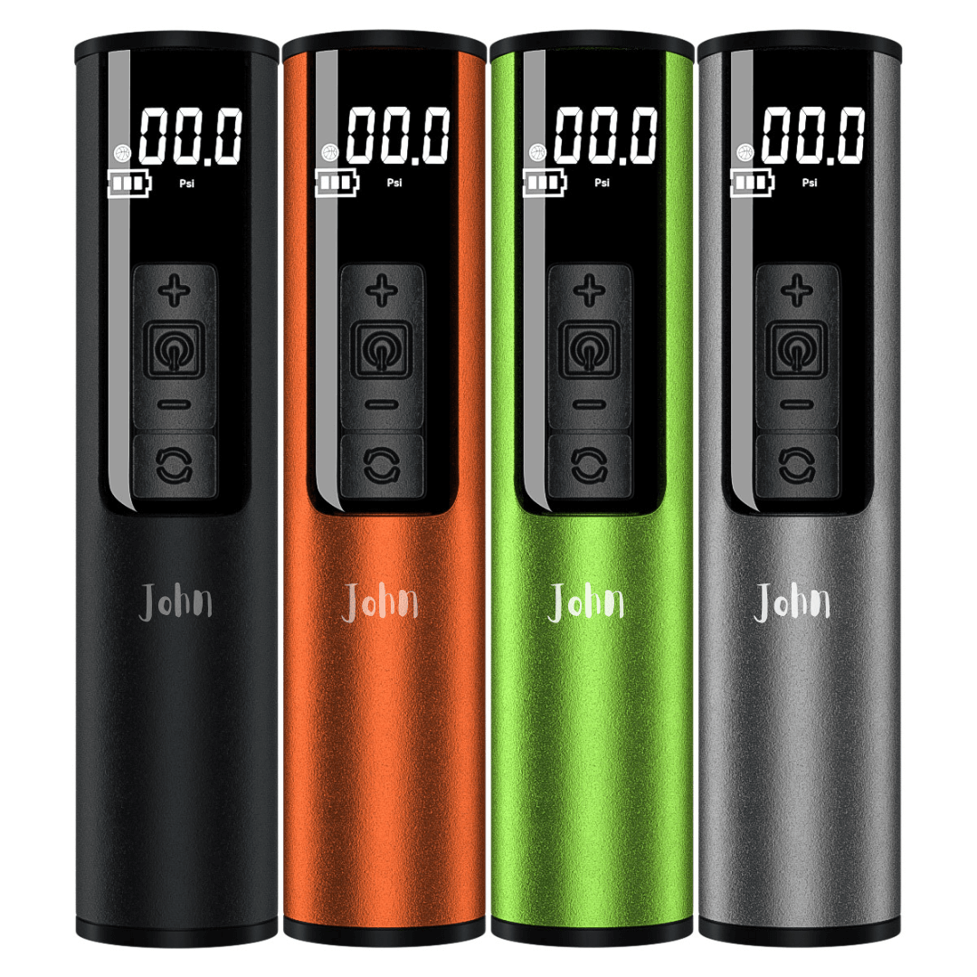 A lineup of four cylindrical, portable air inflators in black, orange, green, and grey.